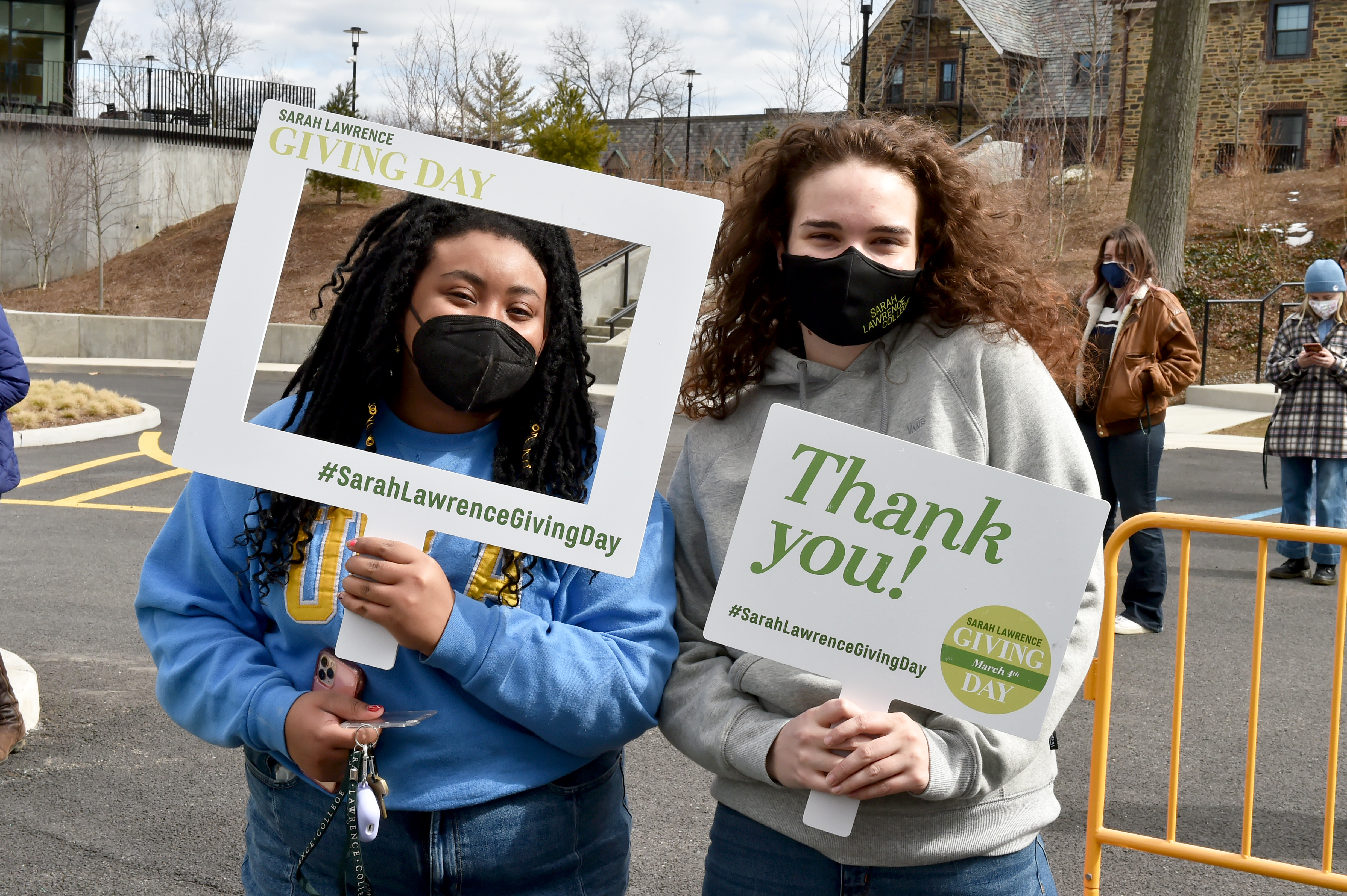 Students holding giving day signs