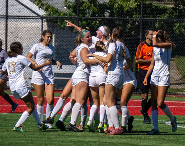 Women's soccer team celebrating a win