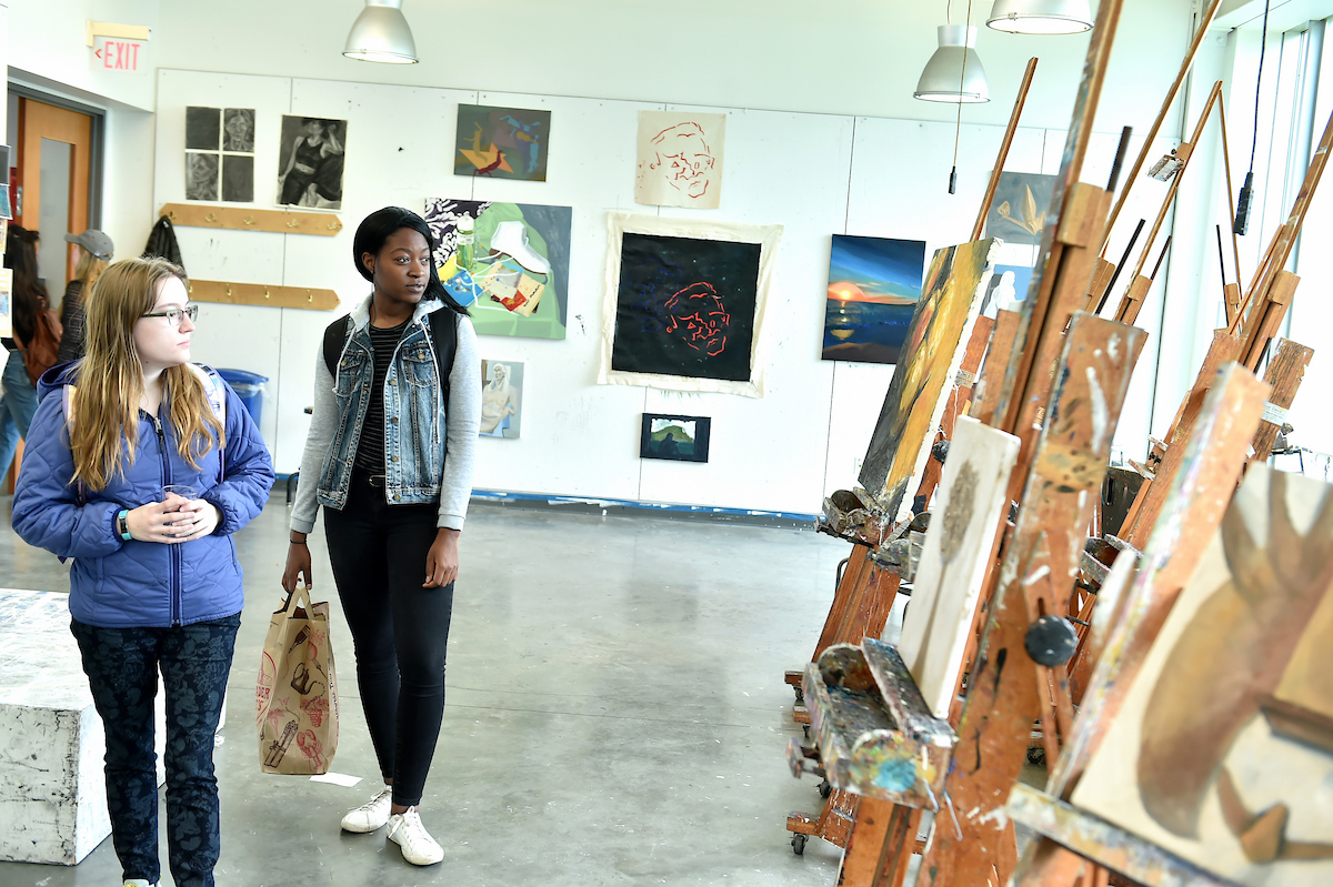 Two students admiring work in an art studio