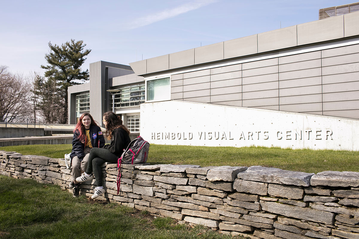 Students sitting outside the Heimbold Visual Arts Center