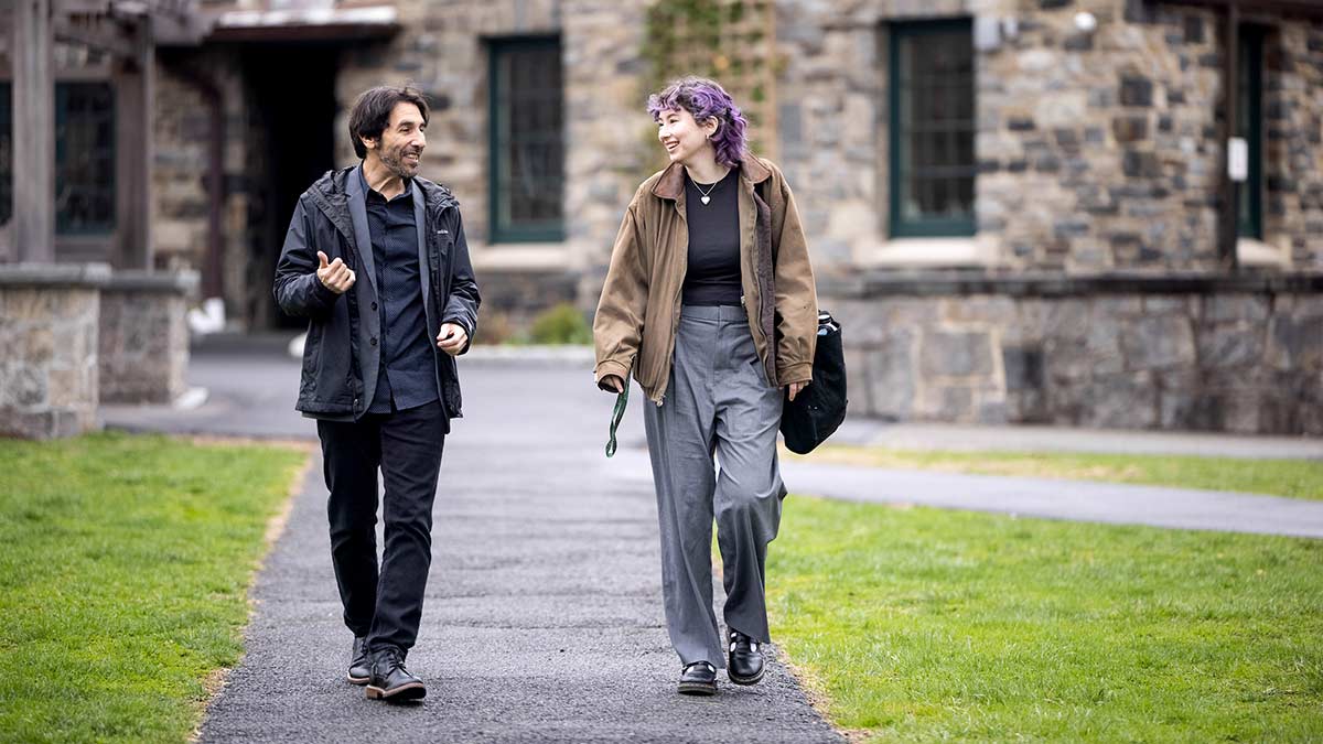 two people walking and talking together outdoors