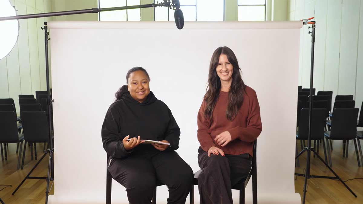 two people sitting talking in a filming studio setup