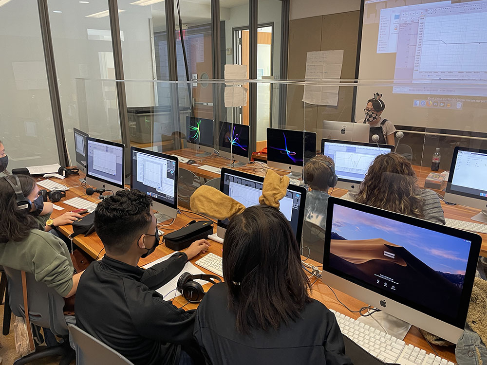 Students working on computers in a digital lab