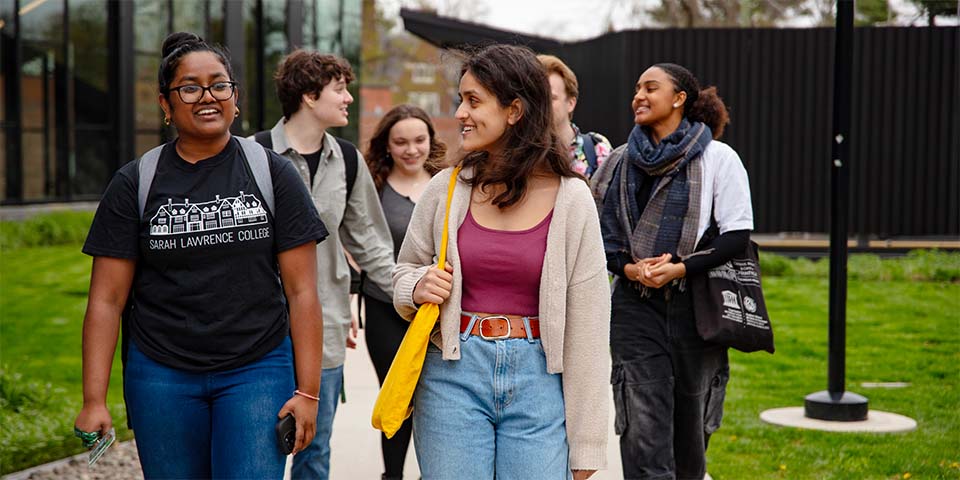 group of students in discussion walking outside