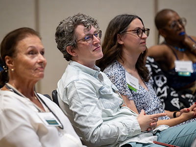 Audience members listening at a reading